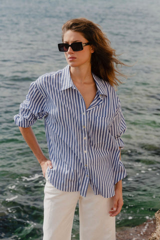 model wears a blue stripe shirt 