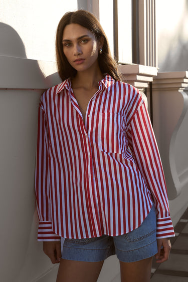 model wears red striped shirt