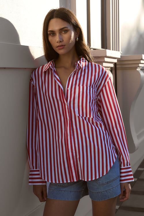 model wears red striped shirt