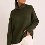 model wears a green turtle neck knit