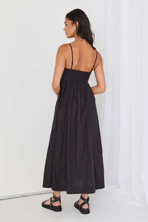 model wears black cotton maxi dress