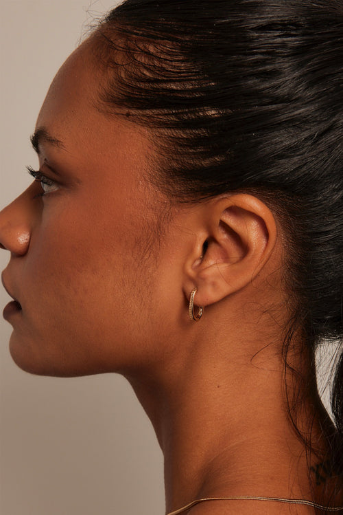 model wearing gold hoop earring
